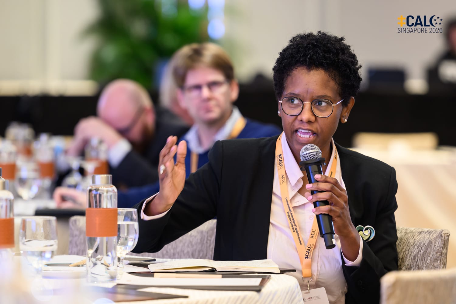 A delegate speaks into a handheld microphone during a session at the Conference in the ballroom at The Fullerton Hotel Singapore.